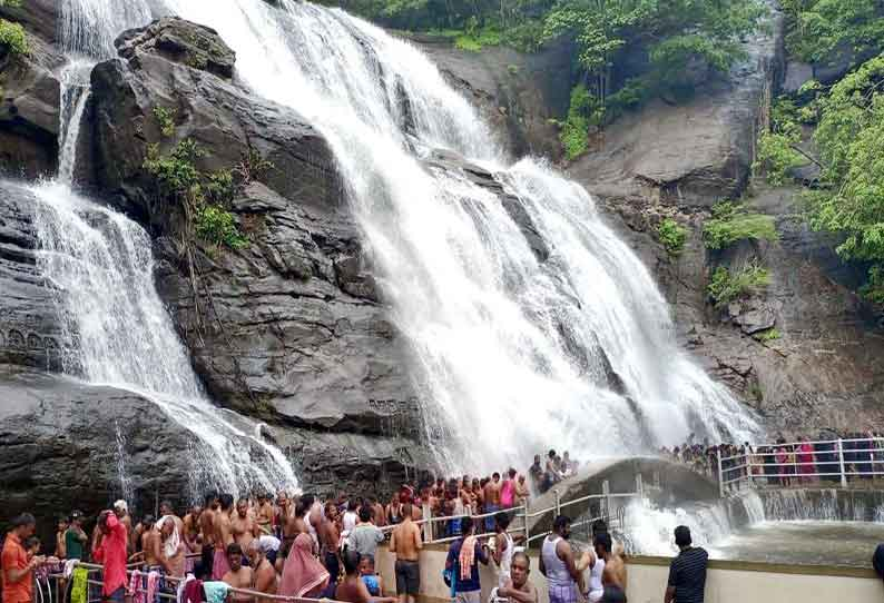 Water gushing out of Courtallam Falls; Exciting bath for tourists